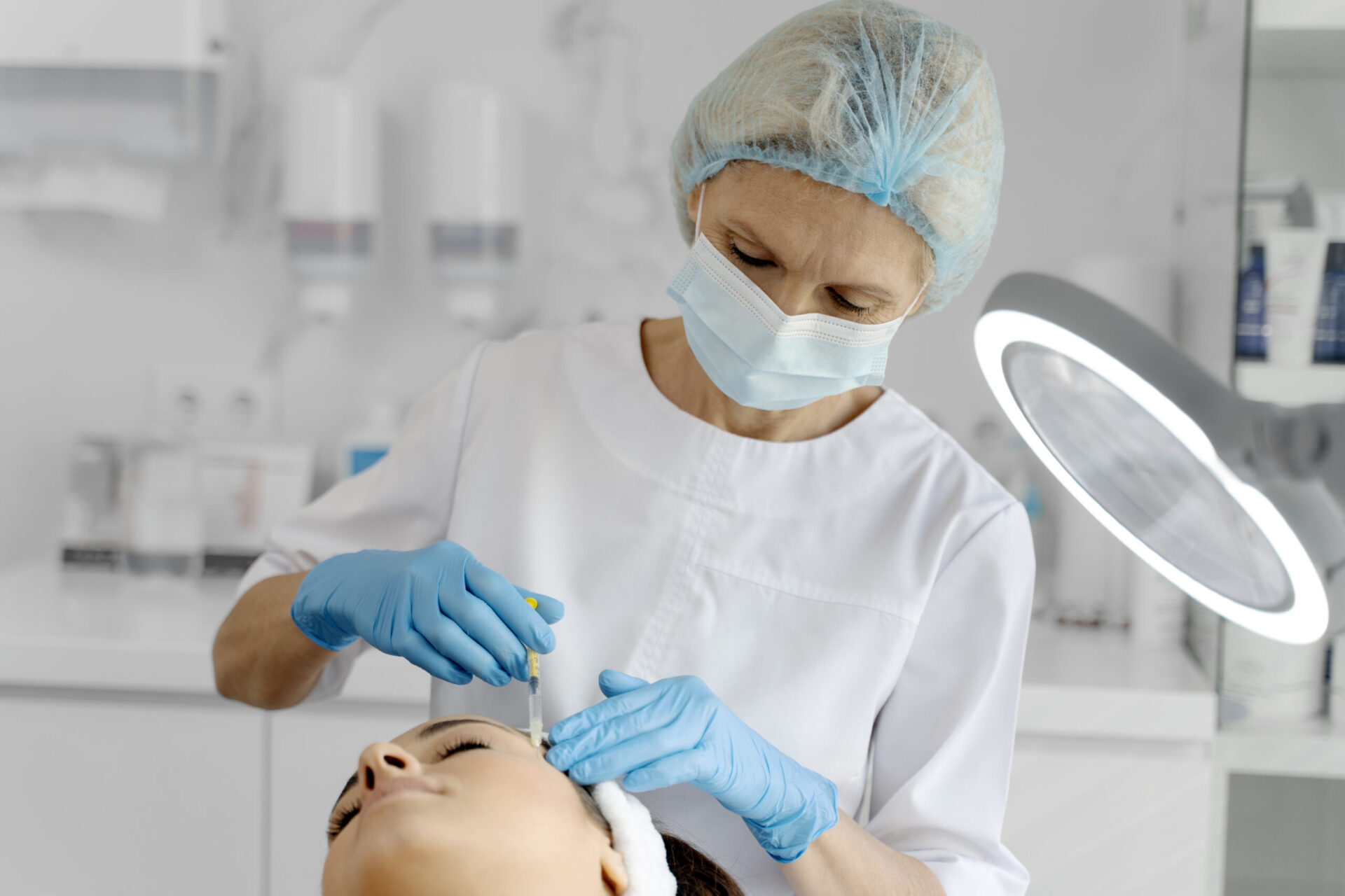 Cosmetologist does prp therapy on the face of a beautiful woman in a beauty salon.